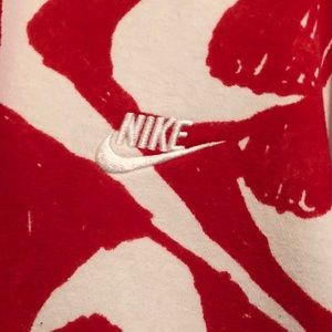 Red and white Nike Swoosh hooded sweatshirt.